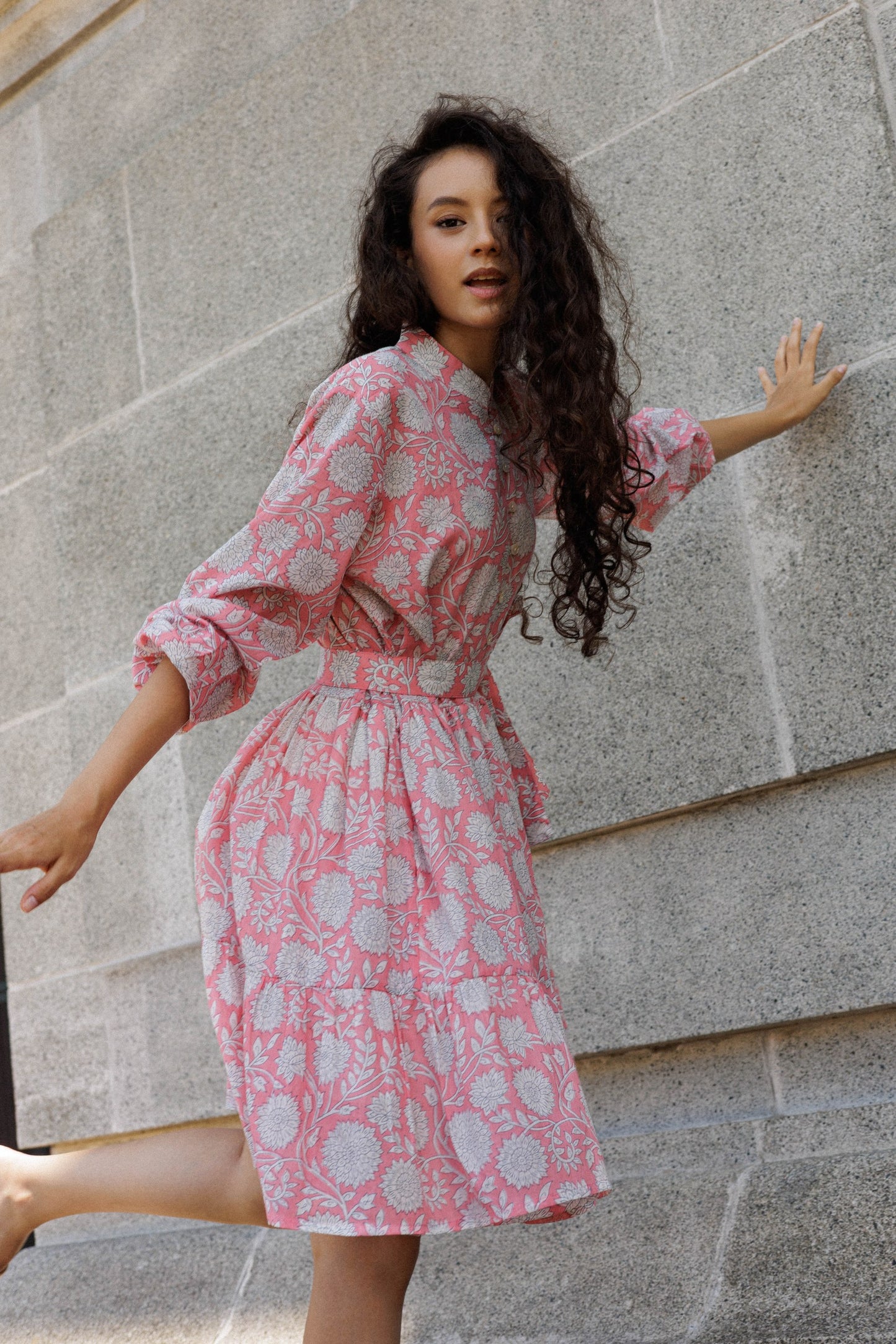 Feminine peach cotton mini dress with elasticated sleeves , lining, pockets, and handcrafted floral block print